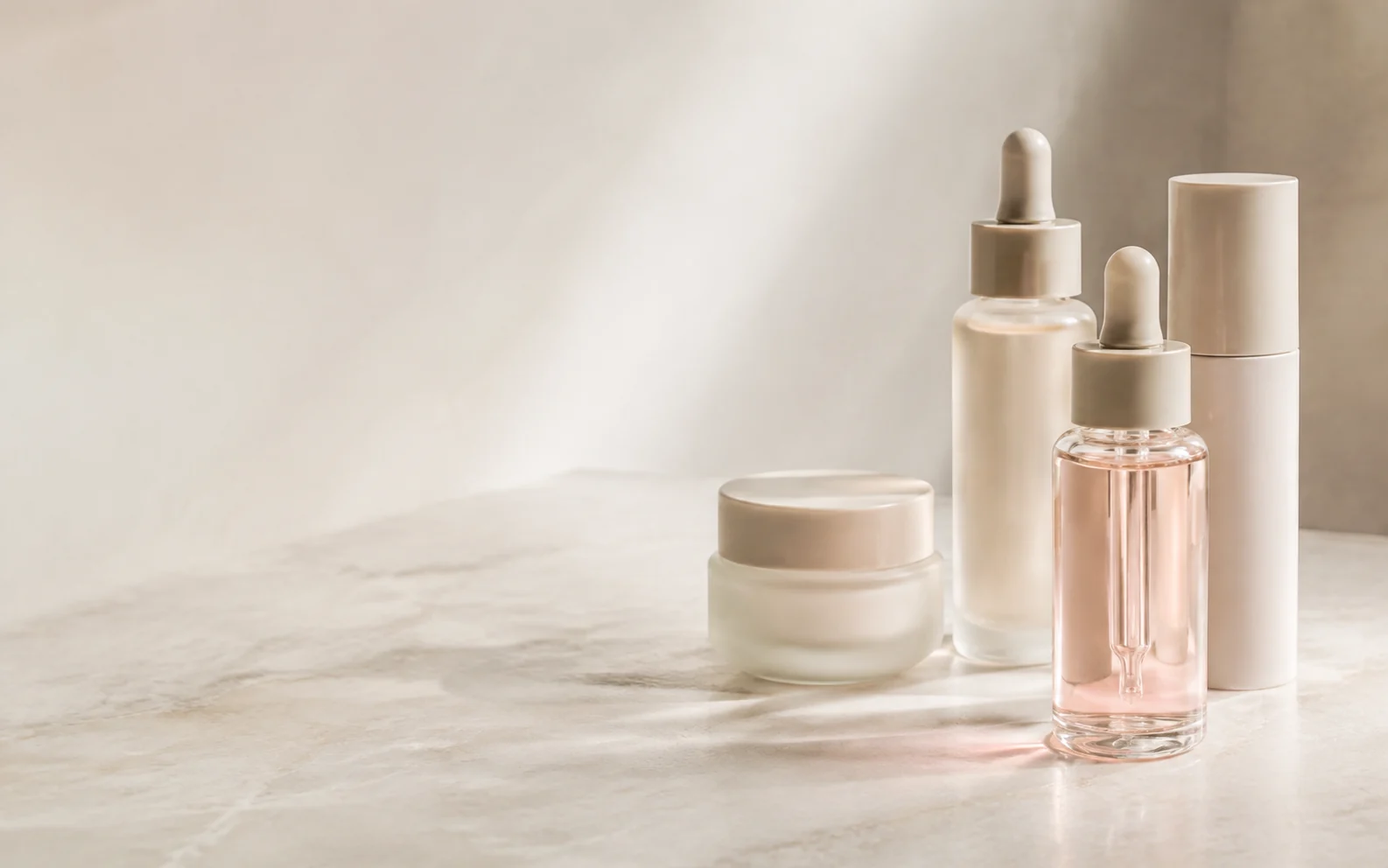 Cream and serum packaging in warm sunlight